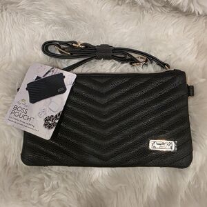 The Itzy Ritzy Boss Pouch is available in black and brown with white, and is des